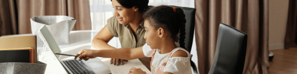 Teacher and child with computer